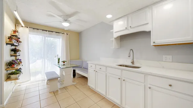 a kitchen with white cabinets appliances and sink