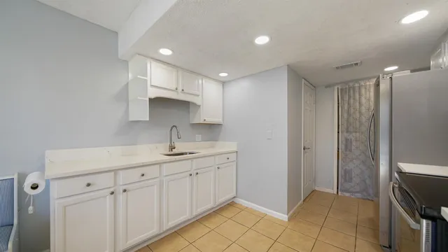 a kitchen with granite countertop a stove and a refrigerator