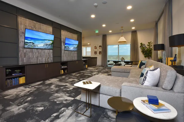 a view of a white house with a yard table and chairs