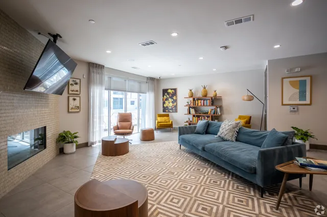 a kitchen with granite countertop a stove a sink and a refrigerator