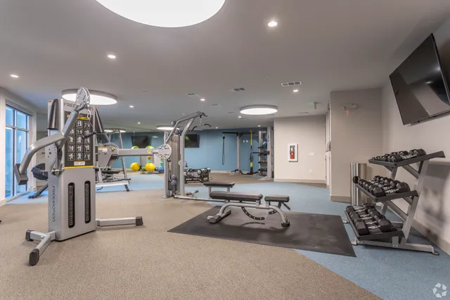 a room with gym equipment and a large window