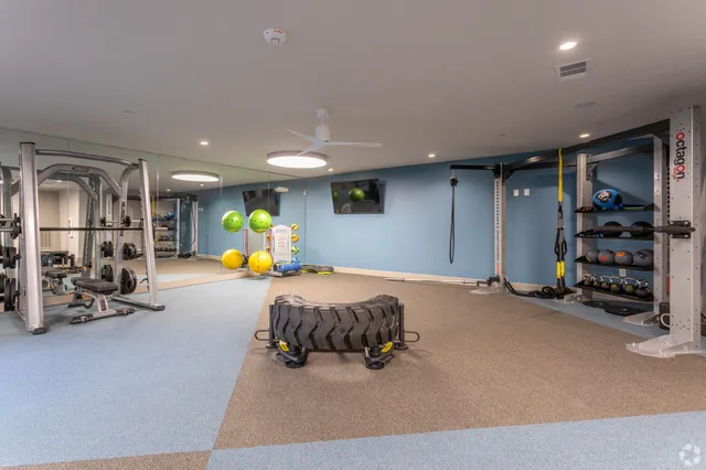 a room with gym equipment and a flat screen tv