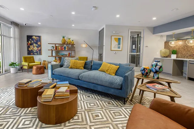 a living room with furniture and kitchen view