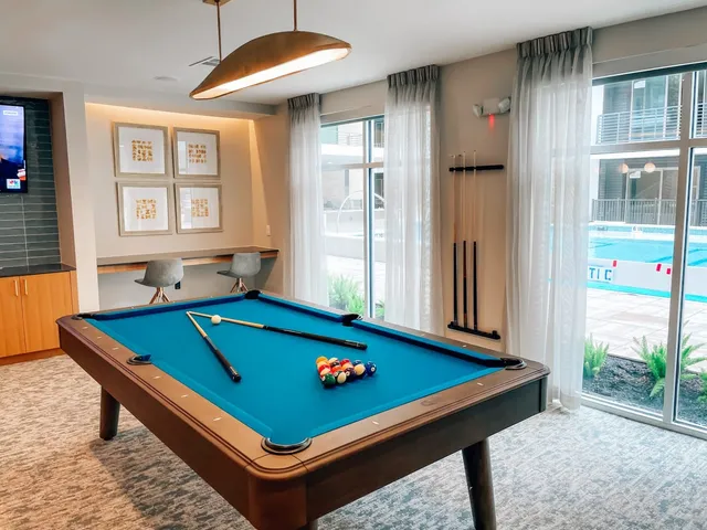 a living room with furniture a table and chairs