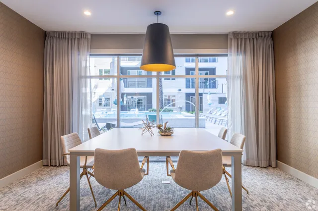 a room with pool table and windows
