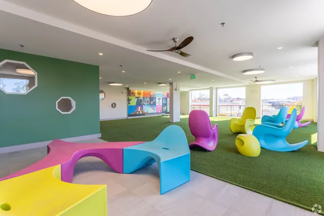 a view of a room with furniture and floor to ceiling window