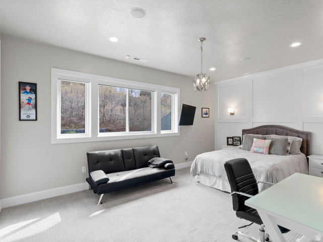 614 East High Lane Alpine, UT 84004 - Photo 54 of 75 Bedroom with carpet, a decorative wall, and suspended lighting