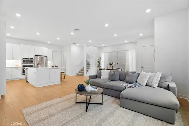 a living room with furniture kitchen and a table