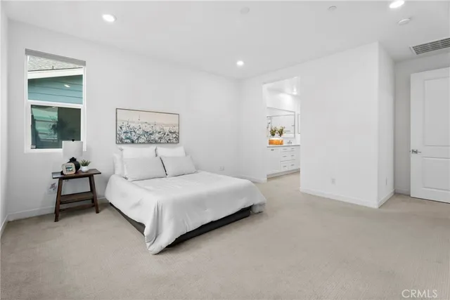 a spacious bedroom with a bed and a couch