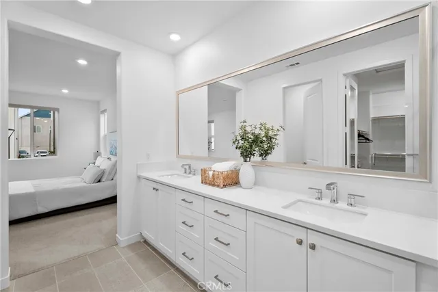 a bathroom with double vanity sinks double vanity tub and a mirror
