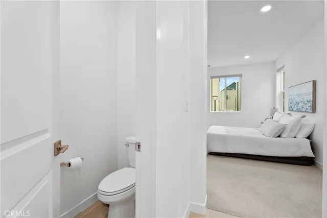 a living room with furniture and a toilet