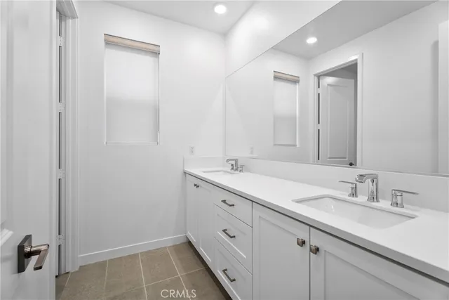 a bathroom with a sink double vanity and a mirror
