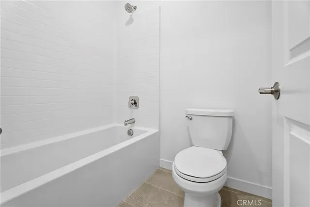a bathroom with a toilet and a bathtub