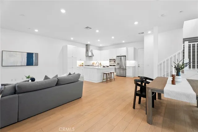 a living room with furniture and kitchen view
