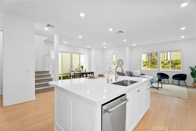 a large white kitchen with a large window