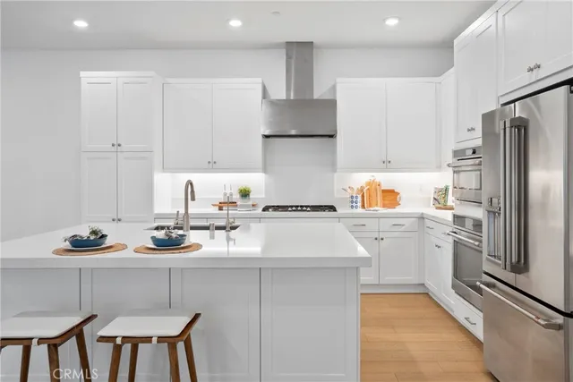 a kitchen with a sink appliances and cabinets