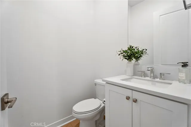 a bathroom with a sink toilet and a mirror