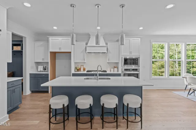 a front view of white house with a yard