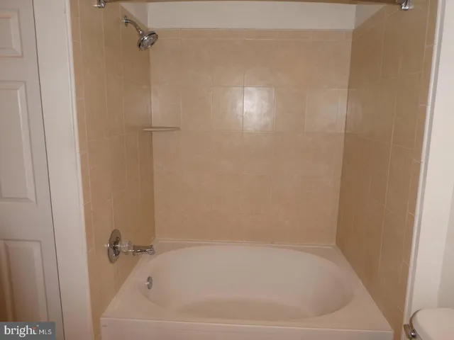 a white bath tub sitting in a bathroom