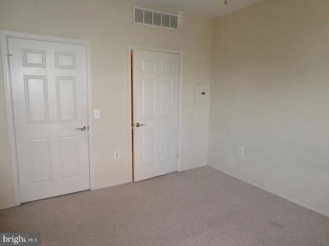 an empty room with closet area