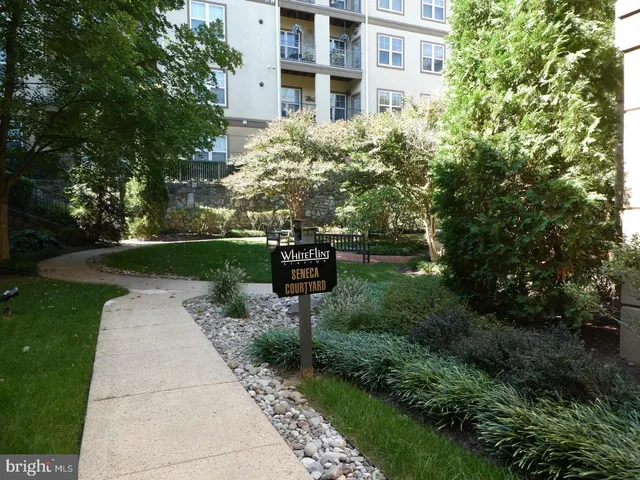 a pathway of a building with a yard