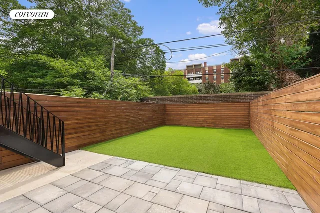 a view of a backyard with wooden fence