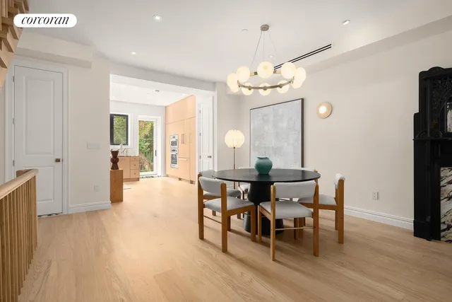 a view of a dining room with furniture wooden floor and chandelier