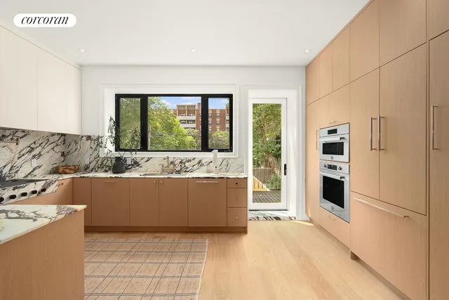 a living room with furniture and large windows