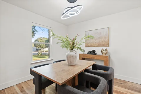 a kitchen with stainless steel appliances a sink stove and wooden floor