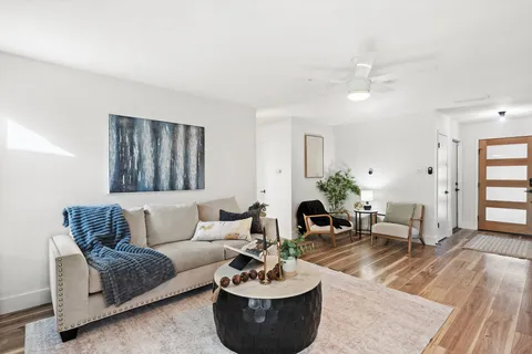 a living room with furniture and a large window