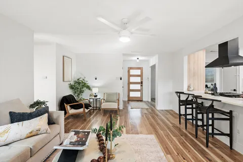 an empty room with a window and wooden floor
