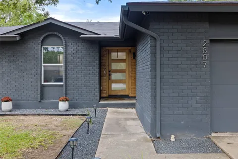 a kitchen with a sink a stove a dining table and chairs
