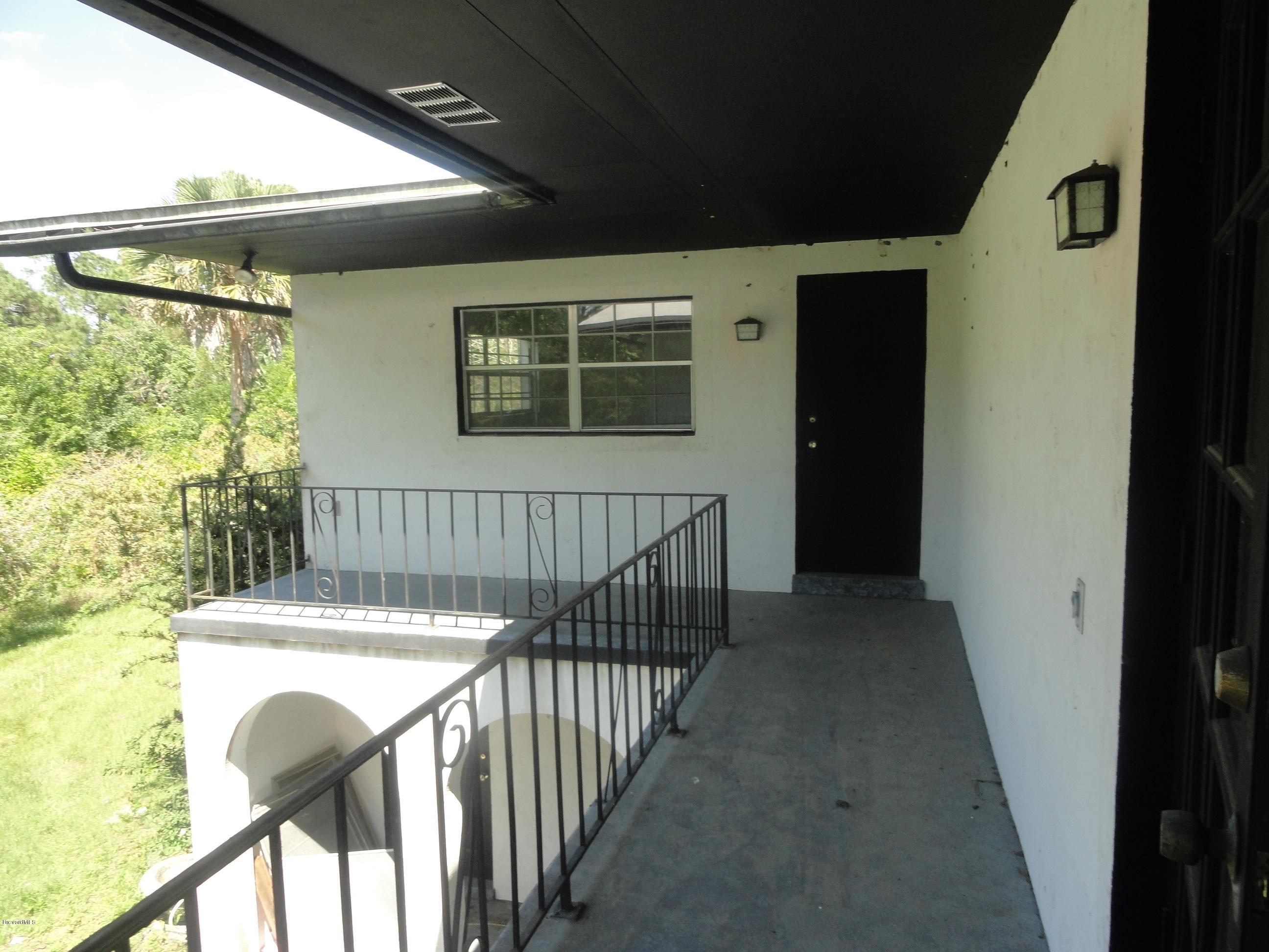 4350 Pinewood Road Melbourne, FL 32934 - Photo 14 of 43 UPSTAIRS BALCONY- DOOR TO MASTER BEDROOM