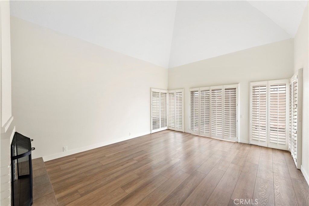 23892 Taranto Bay Dana Point, CA 92629 - Photo 12 of 54 an empty room with wooden floor and windows