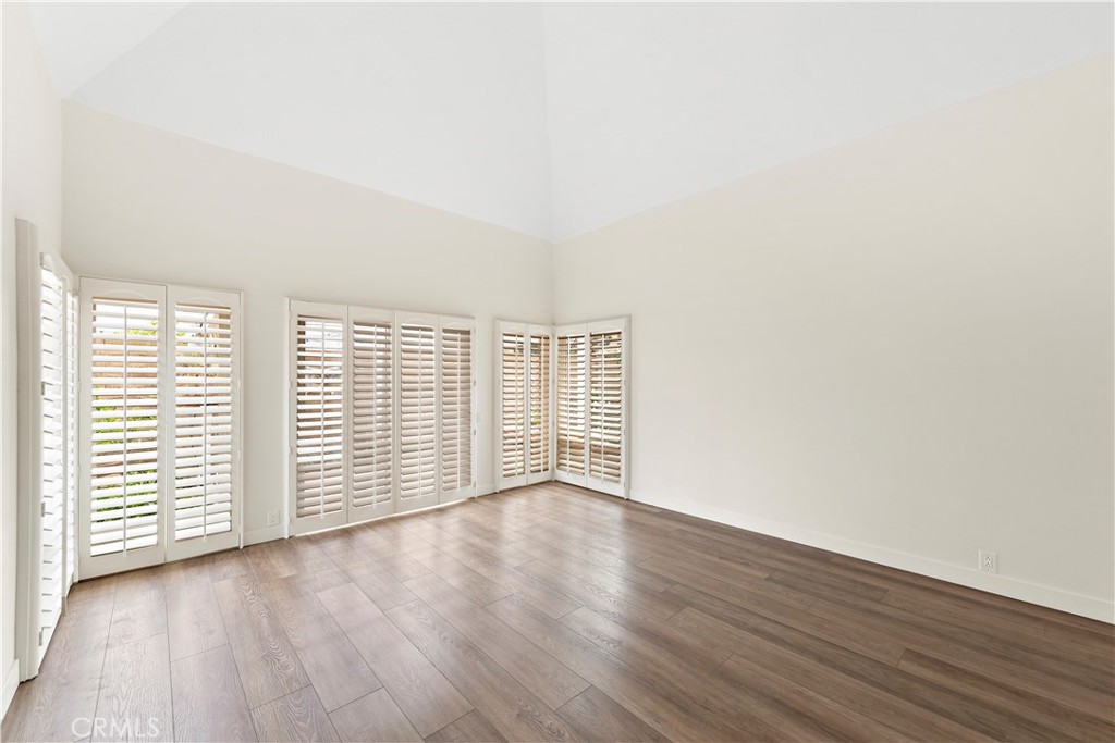 23892 Taranto Bay Dana Point, CA 92629 - Photo 14 of 54 an empty room with wooden floor and windows