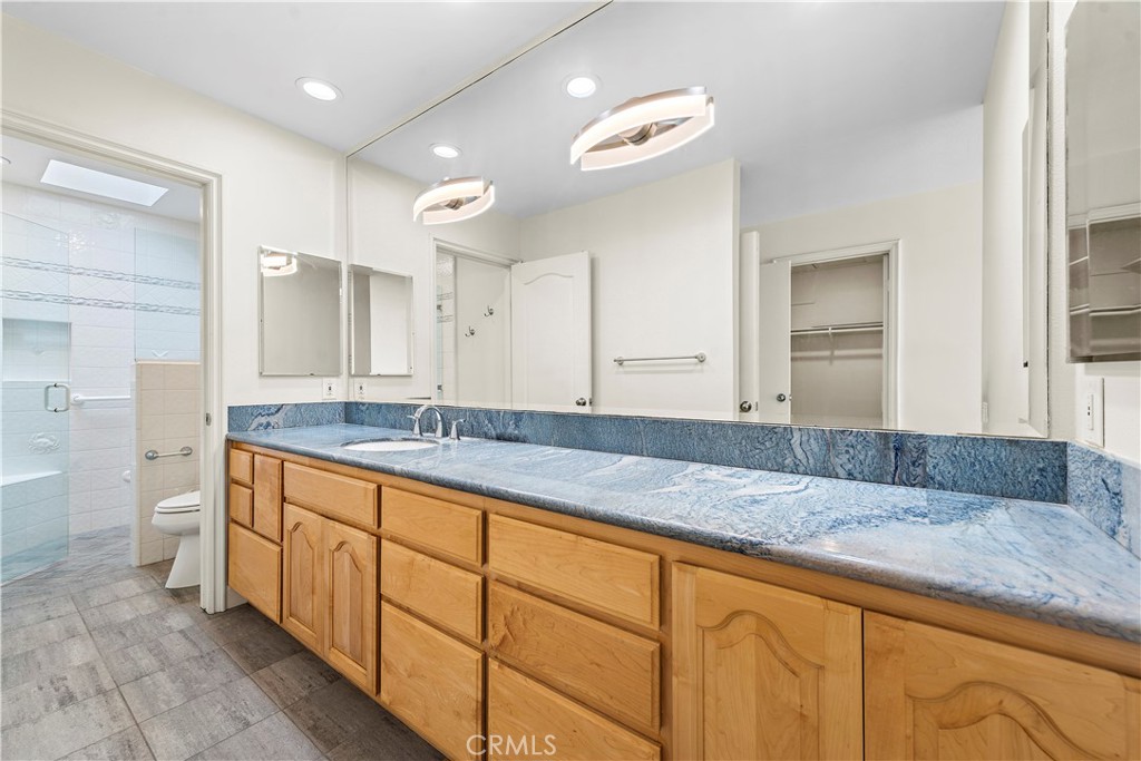 23892 Taranto Bay Dana Point, CA 92629 - Photo 18 of 54 a bathroom with a granite countertop double vanity sink and mirror