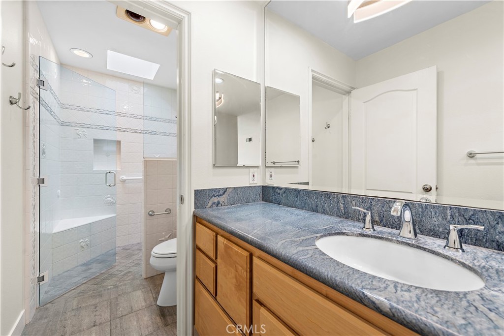23892 Taranto Bay Dana Point, CA 92629 - Photo 19 of 54 a bathroom with a granite countertop double vanity sink toilet mirror and bathtub