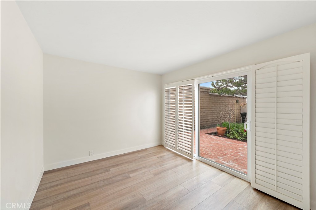 23892 Taranto Bay Dana Point, CA 92629 - Photo 22 of 54 an empty room with wooden floor and windows