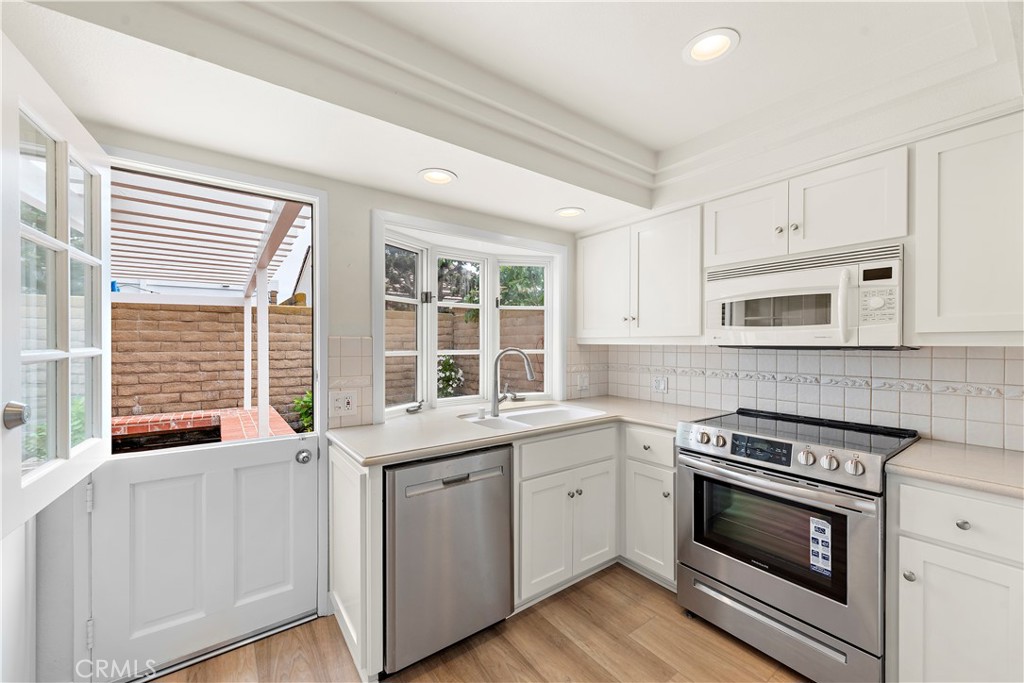 23892 Taranto Bay Dana Point, CA 92629 - Photo 5 of 54 a kitchen with stainless steel appliances white cabinets and a sink