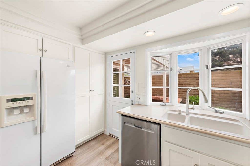 23892 Taranto Bay Dana Point, CA 92629 - Photo 6 of 54 a kitchen with a sink and a refrigerator