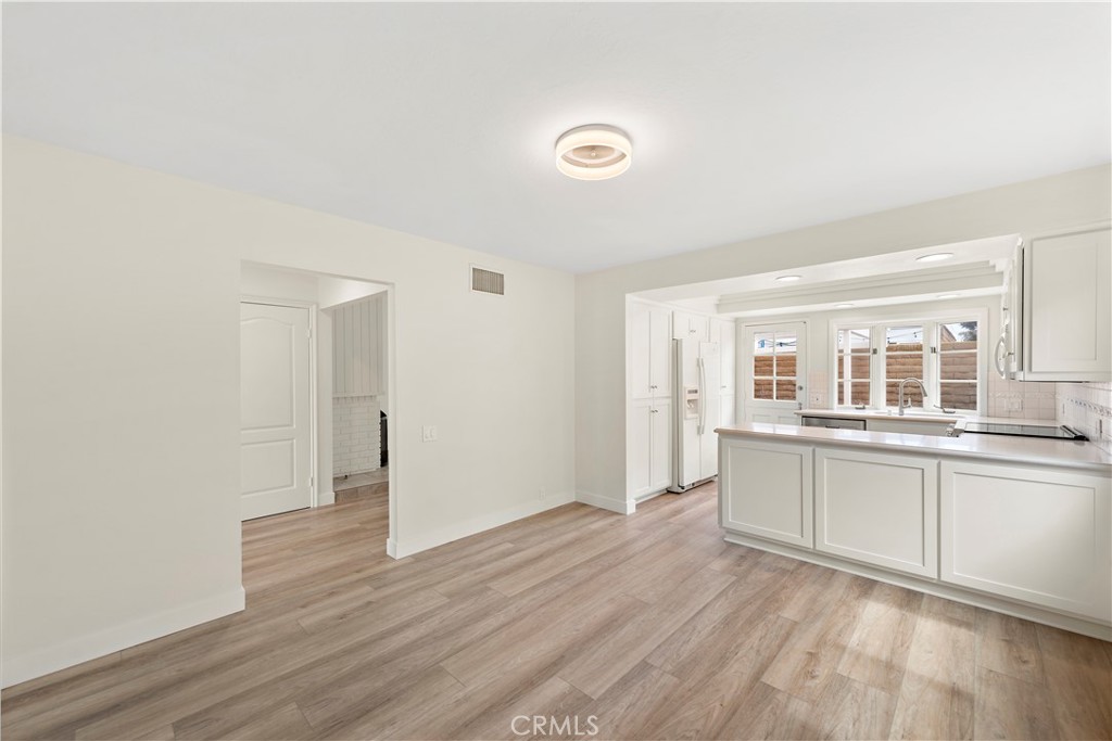 23892 Taranto Bay Dana Point, CA 92629 - Photo 8 of 54 a view of a kitchen with wooden floor and a window