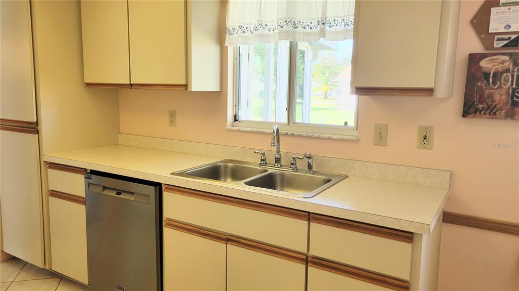 11215 Southwest 63rd Terrace Road Ocala, FL 34476 - Photo 3 of 13 a kitchen with a sink and a cabinets