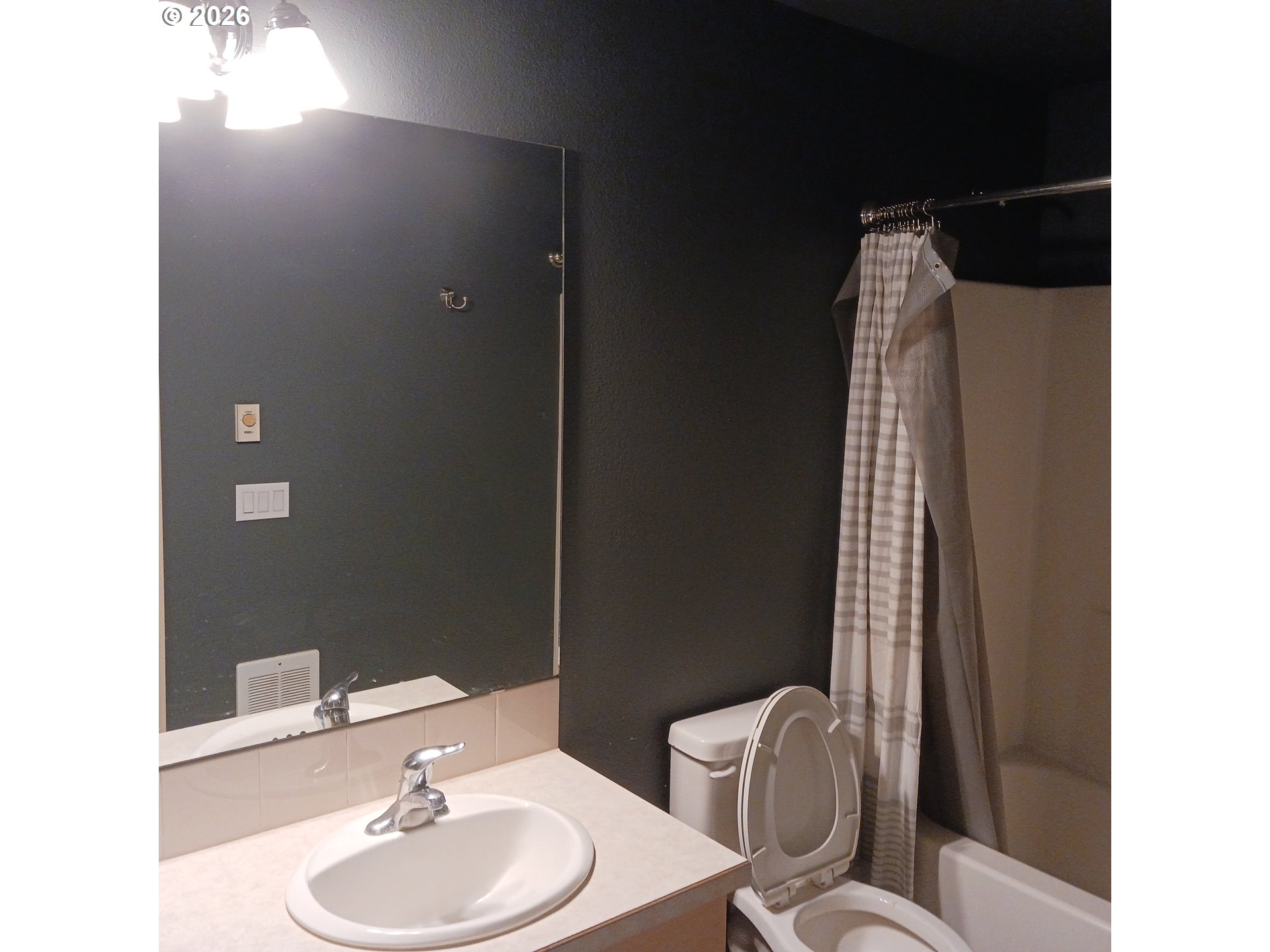 3151 Northeast Wells Acres Road Bend, OR 97701 - Photo 7 of 16 a bathroom with a sink toilet and mirror