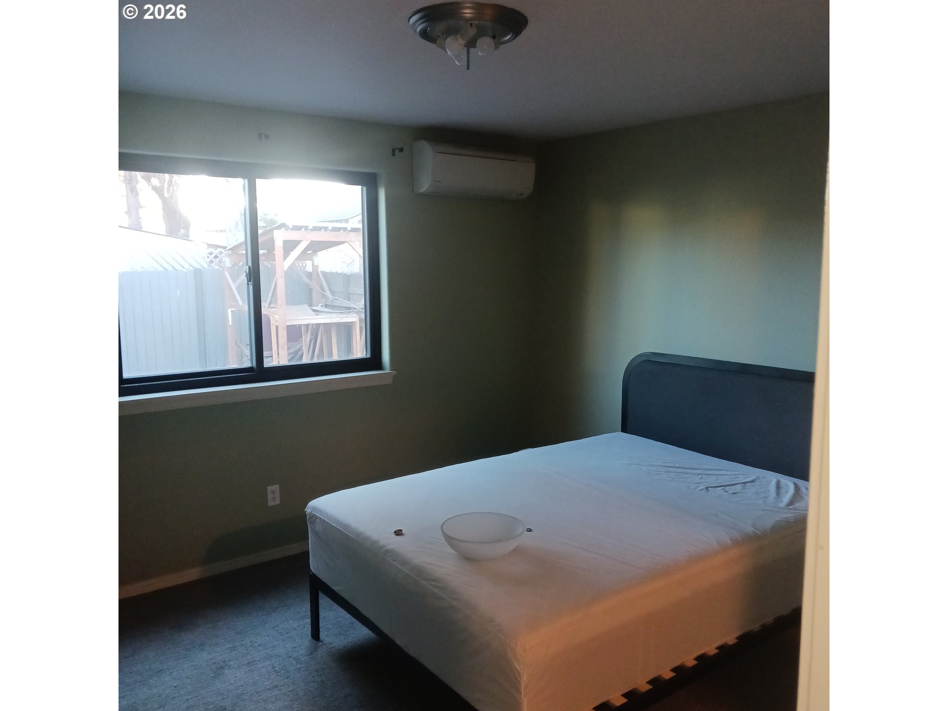 3151 Northeast Wells Acres Road Bend, OR 97701 - Photo 9 of 16 a bedroom with a bed and a window