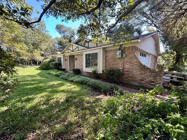 a house that has a tree in front of it