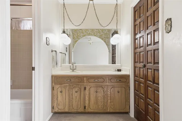 a bathroom with a sink a mirror and a shower