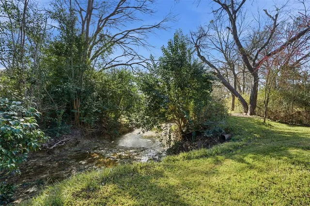 a backyard of a house with lots of green space