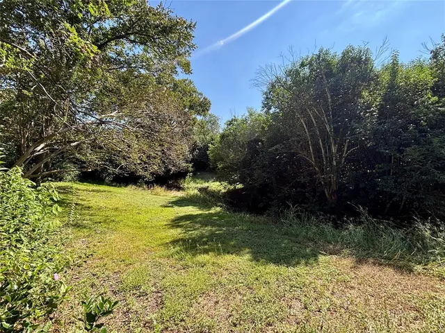 a view of a yard with an outdoor seating