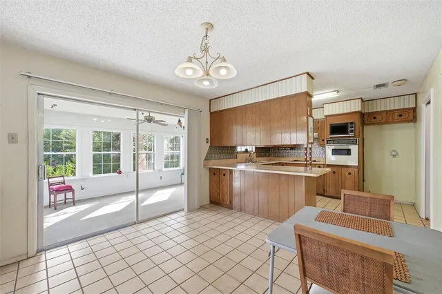 a open kitchen with stainless steel appliances granite countertop a stove and a refrigerator