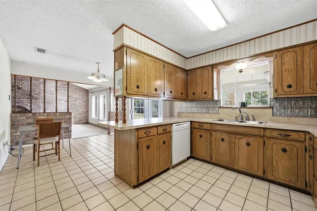 a kitchen with a sink cabinets and window